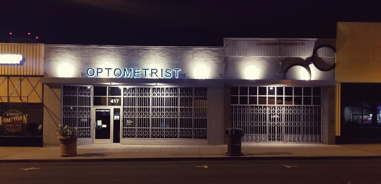 Light-up signage of a Optometrist sign with a circular glasses sign